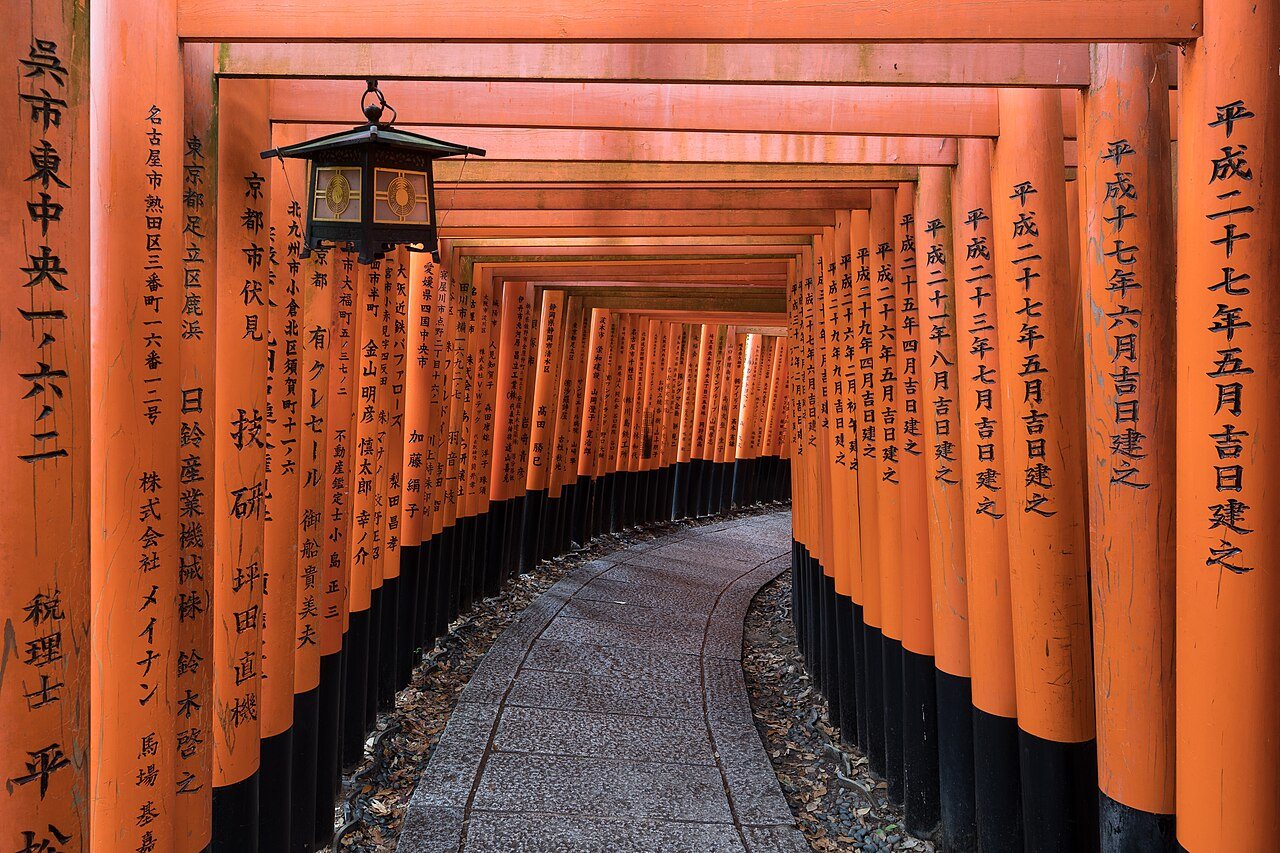 Torii path with lantern at Fushimi Inari Taisha Shrine, Kyoto, Japan